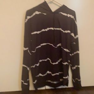 This is a black and white hoodie without pockets.